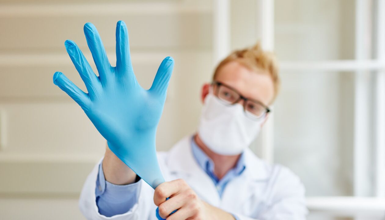 the doctor puts on a glove to massage and prevent prostatitis